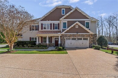 Craftsman-style home with stone siding, an attache