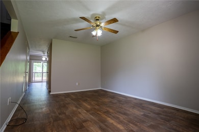 Spare room with dark wood-style flooring, a ceilin