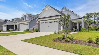 View of front of property featuring an attached garage, concrete driveway, a front yard, and roof with shingles