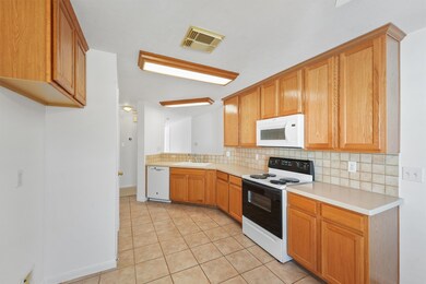 This view of the kitchen shows the cabinet space a