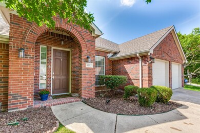 View of exterior entry with a garage