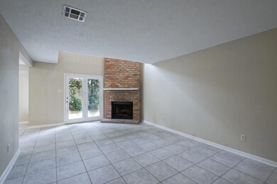 Living room with woodburning fireplace and ceramic