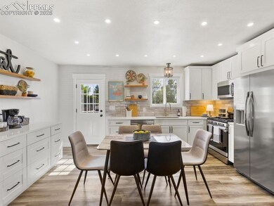 Kitchen featuring open shelves, white cabinets, appliances with stainless steel finishes, backsplash, and recessed lighting