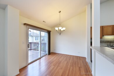 Dining room with vaulted ceiling and chandelier. S