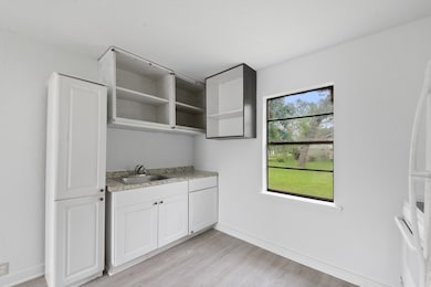 This photo shows a bright, minimalist kitchen area