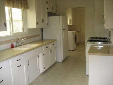 Pleasant sunny kitchen with fridge, microwave, was