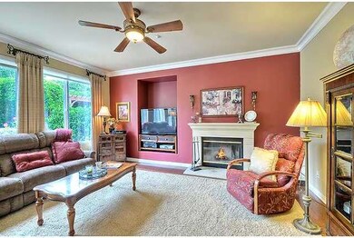 The cozy family room boasts crown moldng, designer