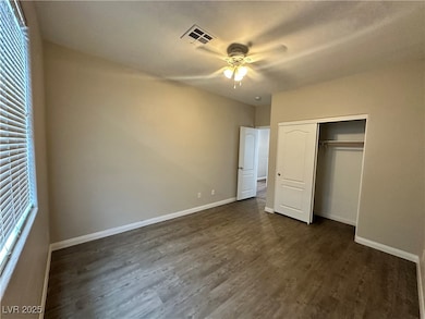 Unfurnished bedroom featuring dark wood-style floo