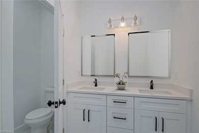 Bathroom featuring double vanity and toilet