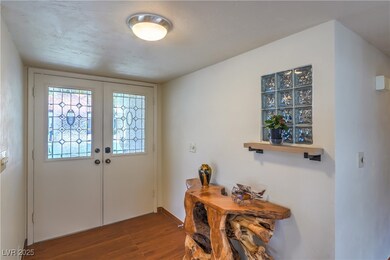Entrance foyer featuring wood finished floors, fre