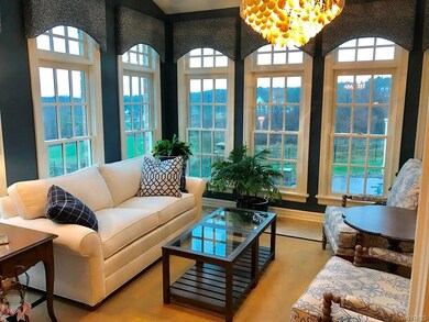 Sunroom...surrounded by wall of windows and custom