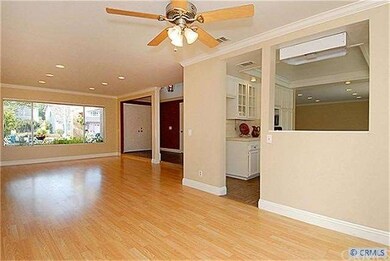 Living Room with Crown Molding and Laminate Floors