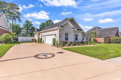 View of front of property featuring brick siding, driveway, a garage, and roof with shingles