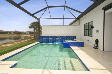 Outdoor pool with an outdoor hot tub, a patio, a water view, and glass enclosure