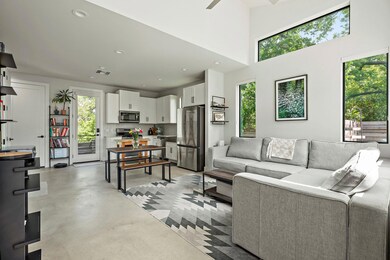 Living room featuring concrete flooring, recessed