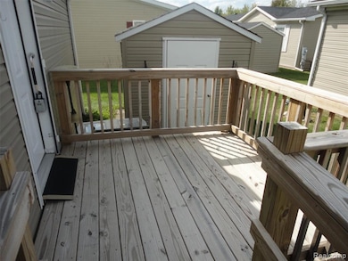Wooden terrace featuring a storage shed