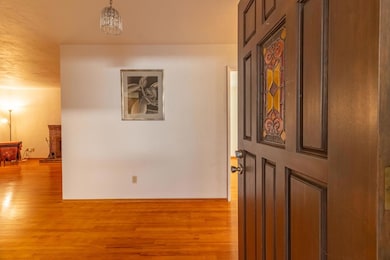 Main livingroom featuring beautiful wood floors, brick accent wall and open layout for entertaing.
