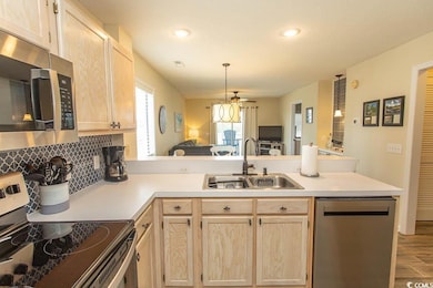 Kitchen featuring a peninsula, light brown cabinet