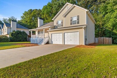 View of front of property with a porch, concrete driveway, an attached garage, and a chimney
