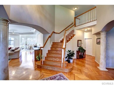 A gracious two-story entry foyer is appointed with