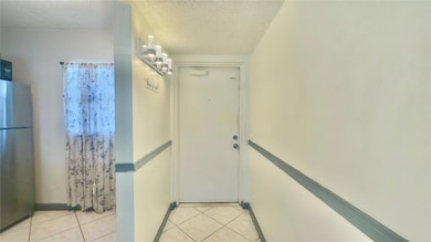 FRONT DOOR AND PARTIAL KITCHEN