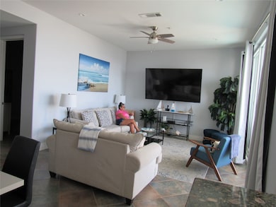 Living room with tall windows looking out across the Gulf