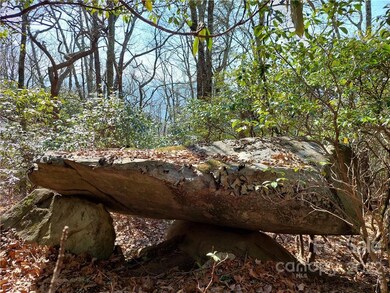Awesome sitting spot just below a building site....lots of rock for landscaping on this lot