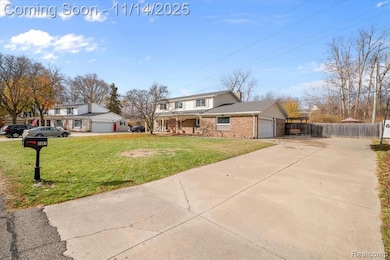 Traditional-style house featuring driveway, a garage, brick siding, a chimney, and covered porch