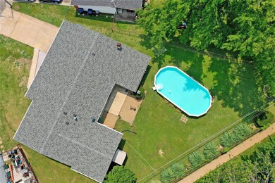 Overhead view of lot showing roof and pool.