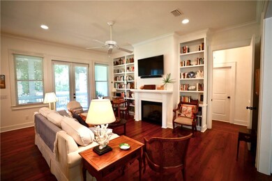 Great room features built in bookcases, gas log fi