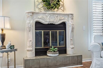 Gas fireplace with gorgeous ornate mantle.