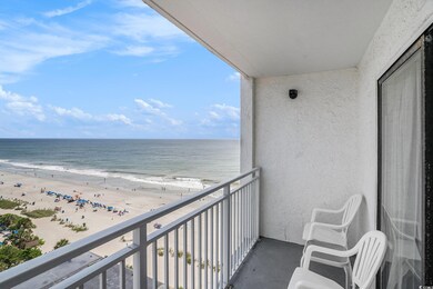 Balcony with view of water and beach and a sunroom