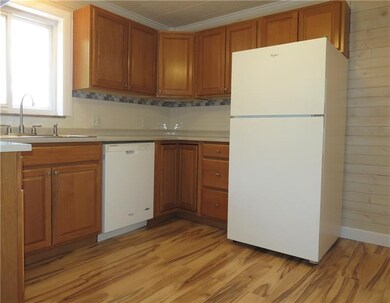 The kitchen has been completely renovated including new cabinets, solid surface countertops, custom backsplash and LVT flooring.