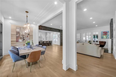 Dining room with wood finished floors, recessed lighting, baseboards, and plenty of natural light
