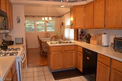 Light filled kitchen with appliances, center sink 