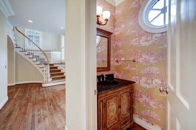The first floor half bath is located off of the En