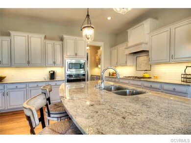 The kitchen boasts maple cabinets in a white linen