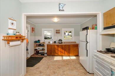 Kitchen with white appliances and ornamental moldi