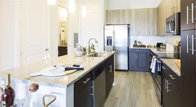 Kitchen featuring a kitchen breakfast bar, stainle