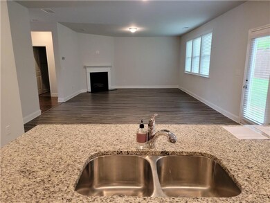 Unfurnished living room with a sink, wood finished