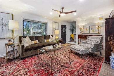 Living room featuring ceiling fan, ornamental mold