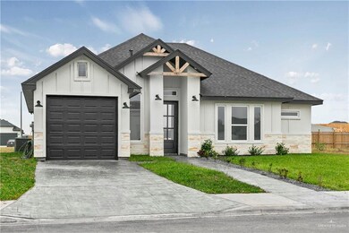 View of front of house with a front yard and a garage