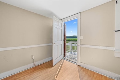 Foyer entrance with wood finished floors and baseb