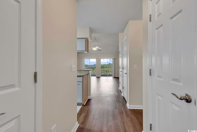 Hall with dark hardwood / wood-style floors
