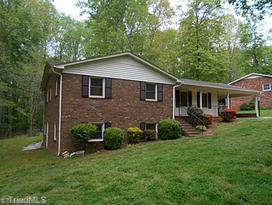 Exterior Front. Lovely brick exterior provides a beautiful contrast to the lush grass and colorful shrubbery.