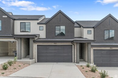 Traditional-style home with concrete driveway, a garage, stucco siding, and roof with shingles
