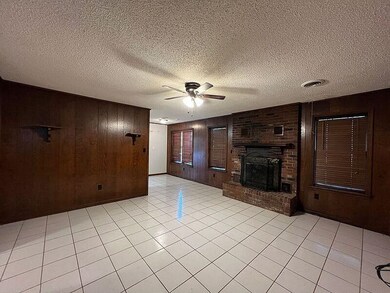 Unfurnished living room with wood walls, ceiling f