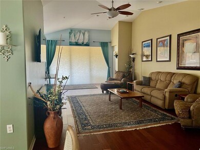 Living area featuring vaulted ceiling, a ceiling f