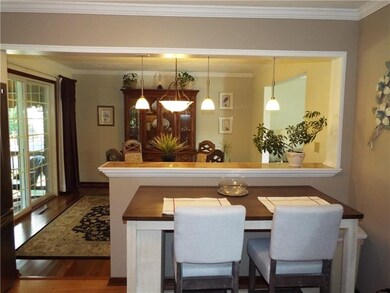 View of dining room from the kitchen. Sliding door