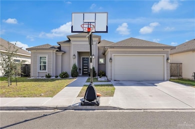 View of front facade featuring driveway, roof with shingles, a garage, and stucco siding